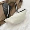 A white bag sitting on top of a brown blanket
