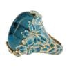 Blue gemstone ring with floral design, angled view