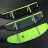 Three different colors of sports waist packs shown on a table
